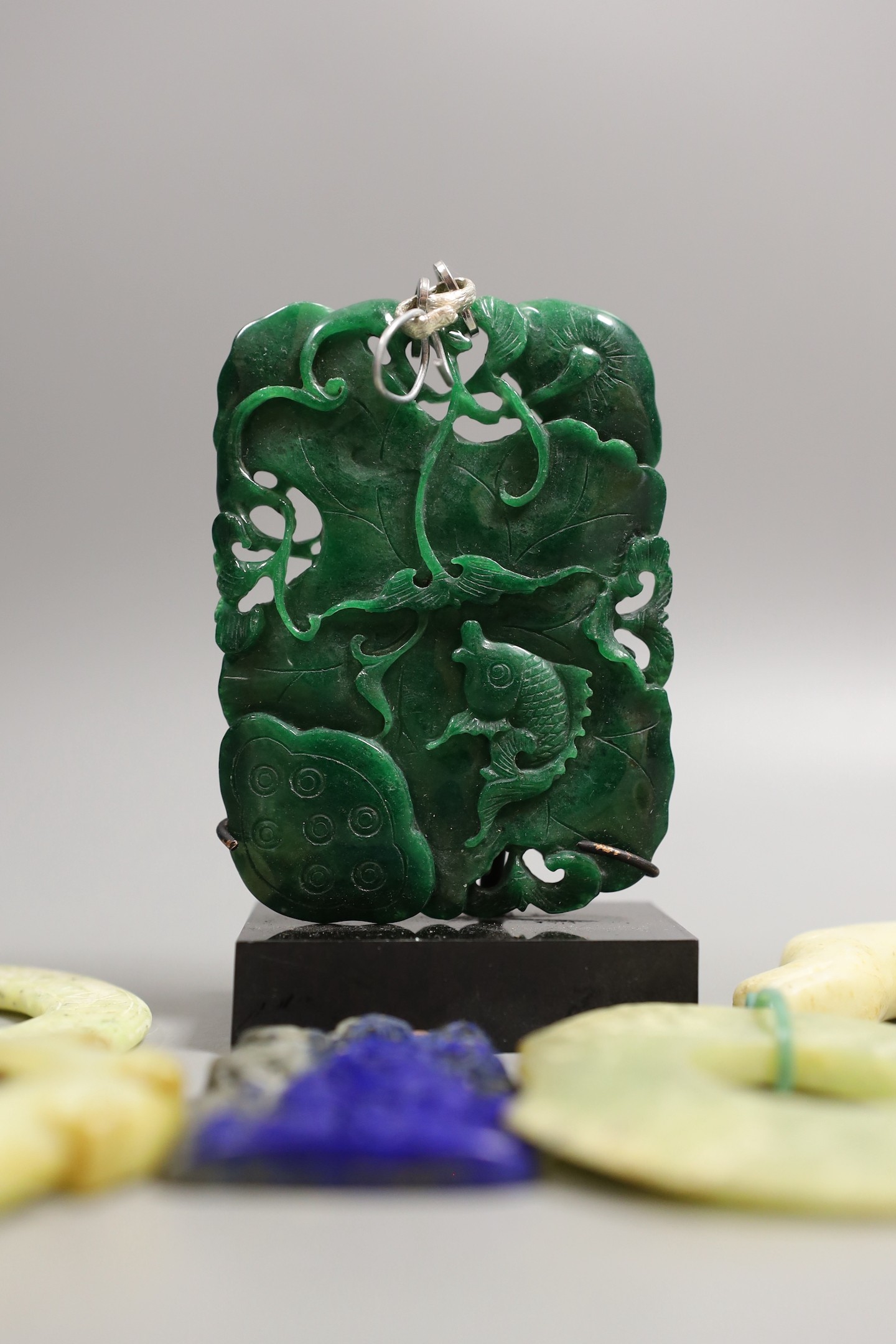 A large Chinese jadeite ‘fish’ plaque, 10 cm high and five various hardstone or bowenite jade plaques